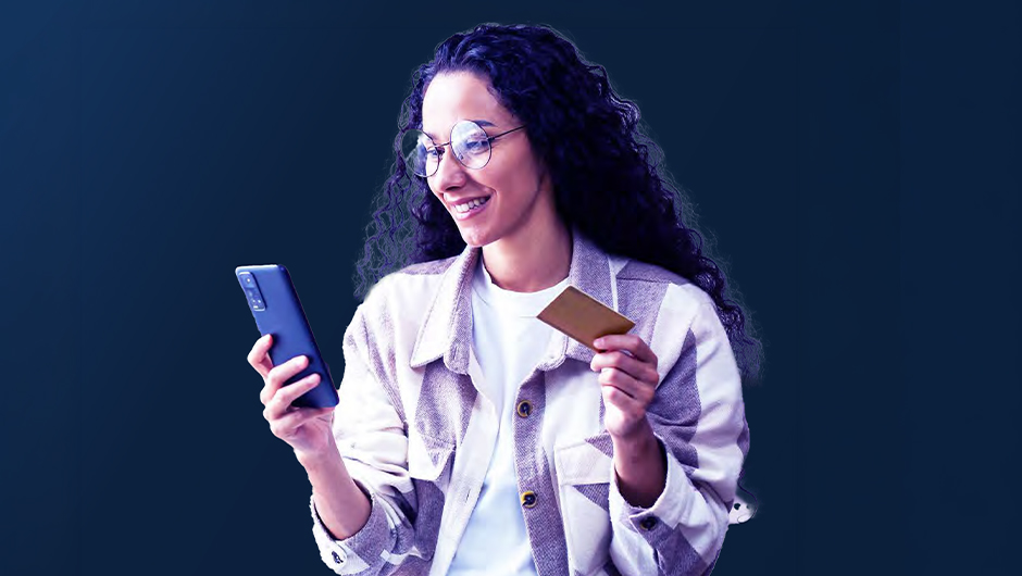 a woman holding a smartphone and credit card