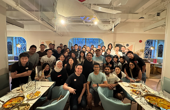 a team photo of audax employees during a team party